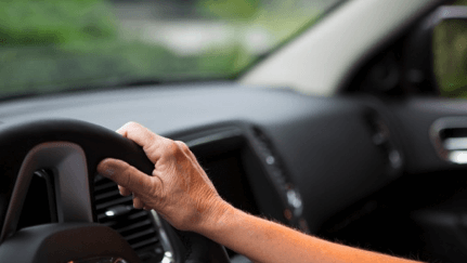 Woman driving a car and learning the steps to take in the aftermath of a car accident